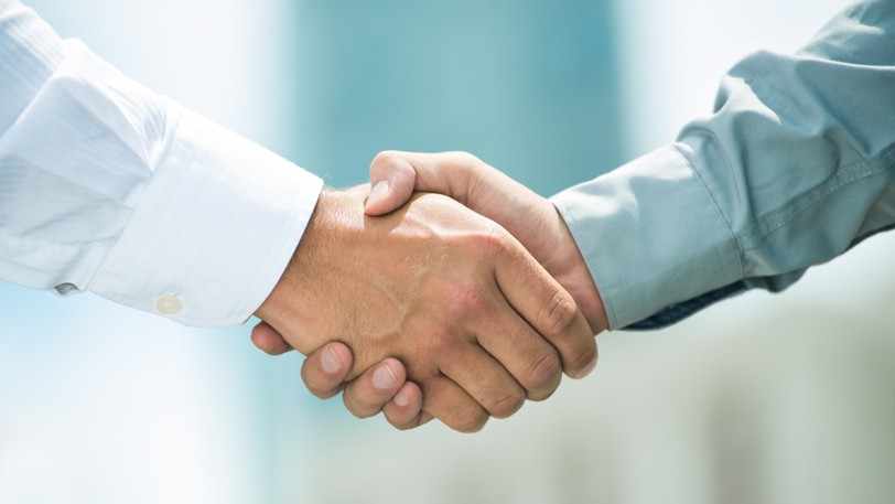 A client shakes hands with their trusted surety bond expert.